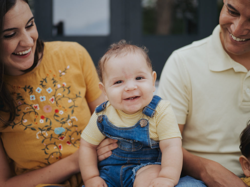Brazilian-American baby with a beautiful bilingual name smiling with his parents