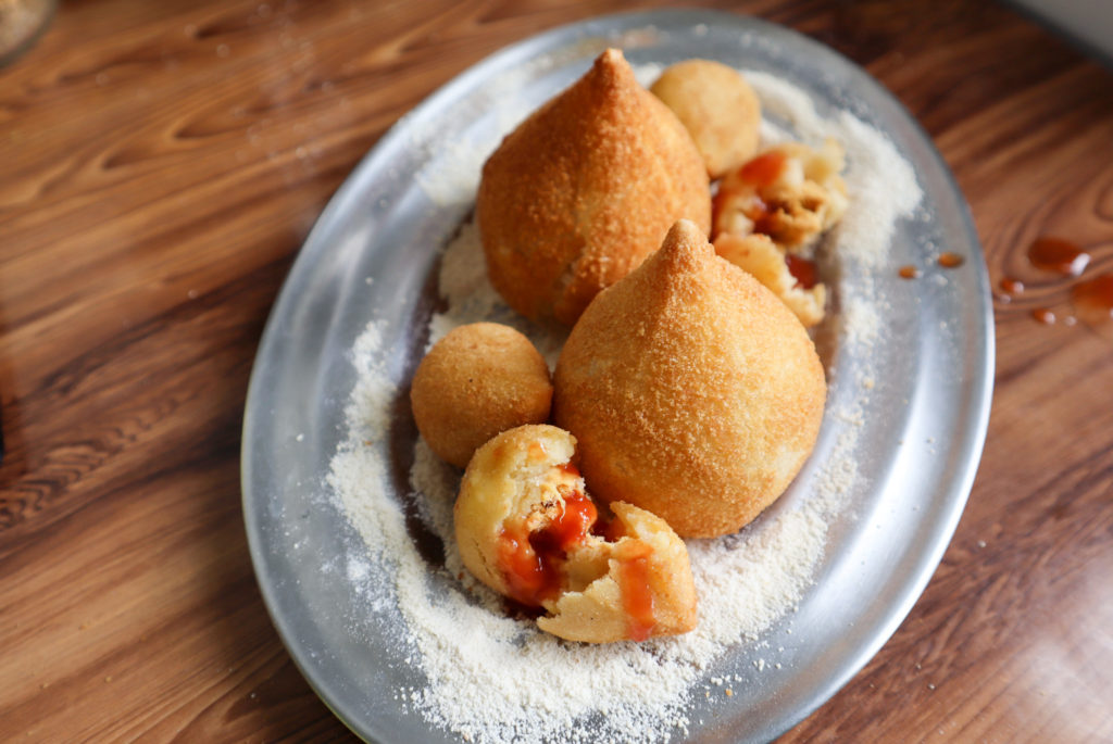 Authentic Brazilian Chicken Coxinha Recipe with coxinha sitting on a plate